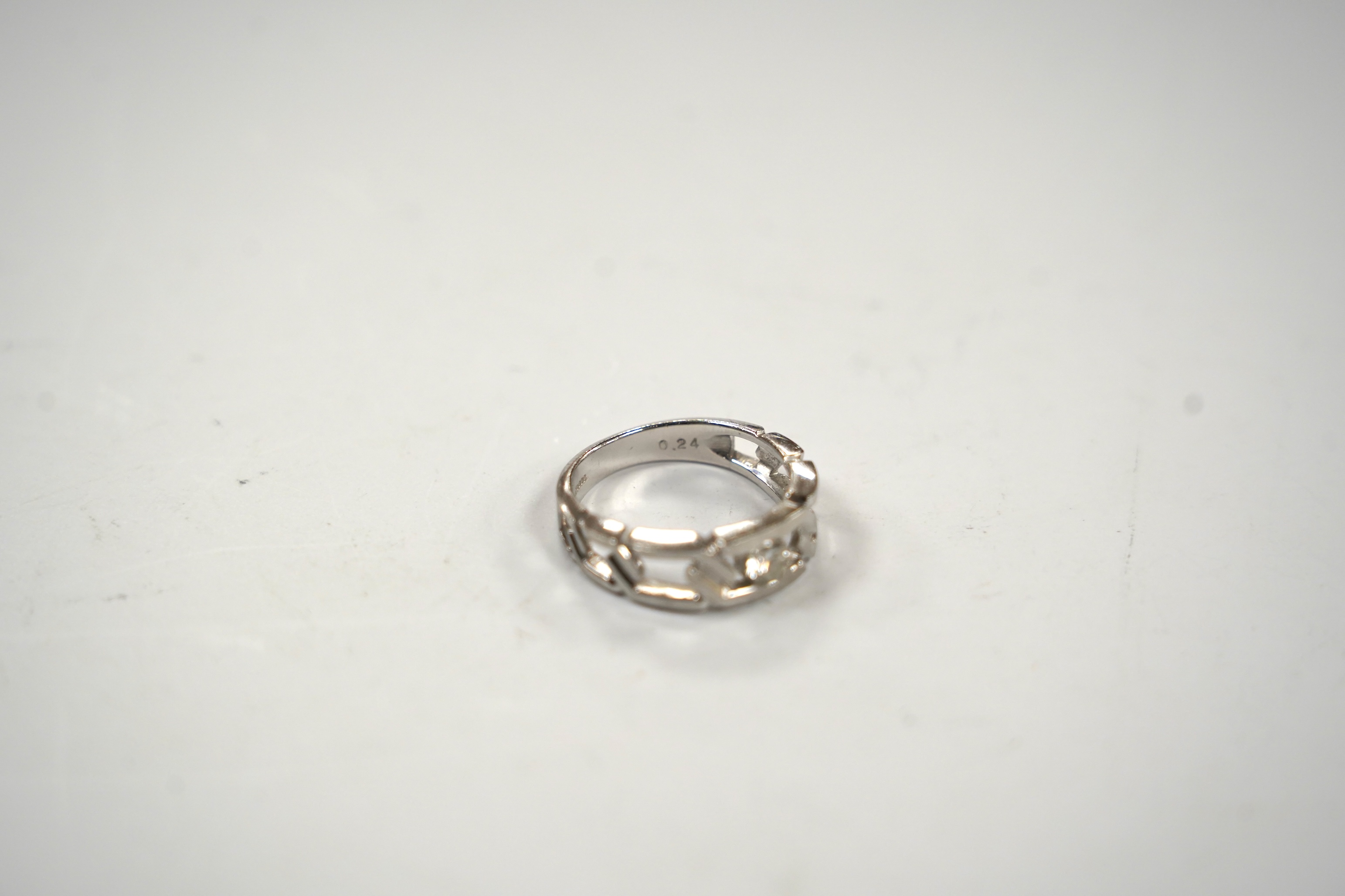 A modern pierced white metal (stamped PT900) and solitaire diamond set ring, size K, gross weight 6.7 grams.